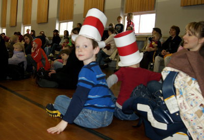 Image: Two brothers sit down to a few stories and songs at the Dr. Seuss Celebration.