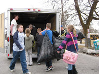 Image: Park Elementary students load bags full of donated supplies onto the trailer headed for The Road Home in Salt Lake City early this morning.