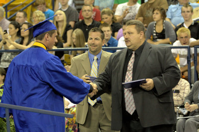 Image: Tyrel Pierson is congratulated by Bardett Bagley and Cache County School Board member