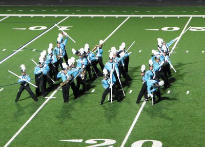 Image: The woodwind sections of the Sky View Marching Band hold a pose during their 2011 “Rock Me Blue” show while performing at Red Rocks Invitational in St. George, Utah.