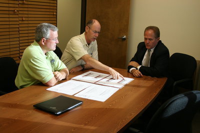 Image: Planning — Councilman William Wood, city manager Jim Gass and mayor Simmons discuss designs for the new Smithfield Police Station.