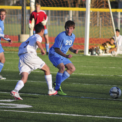 Image: Andy Maughan — Andy Maughan forces a pass from Logan’s Kayd Marquez.