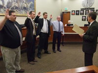 Image: Bart Baird, Jonathan Jenkins, Garrick Hall, and Allen Grunig being sworn in as board members by Business Administrator, Dale Hansen
