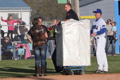 Image: Proposal at Home Plate — Percell Harris (back to us) surprised by her “prize” in the box — Randy Pitcher.
