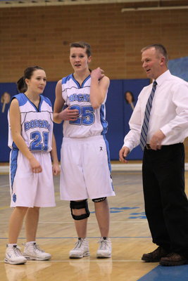 Image: Coach instructs — Sydnee Johnson and Jessica Duffin listening to Coach Paul Hansen during the game.