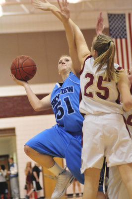 Image: Amy Andrus — Senior center/forward Amy Andrus slides aroung Logan’s Lauren Mott for a basket.