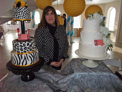 Image: Grace Harvell — Grace Harvell of “the graceful baker” in front of two of her creations.
