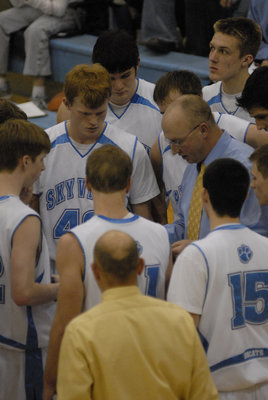 Image: Talking strategy — Coach Anderson discussing the next play during a time out.