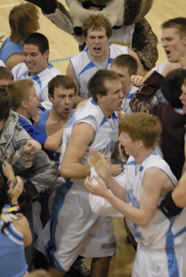 Image: Students storm floor — Skyview students storm the court to congratulate #12 after putting in the last second bucket