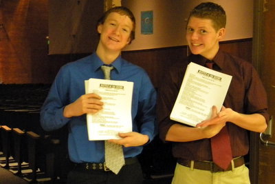 Image: Get your programs — Zakk Rhodes and Kyle Petersen hand out programs