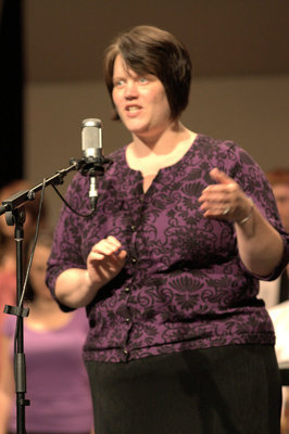 Image: Concert Choir director Karen Tuescher introduces the choir.