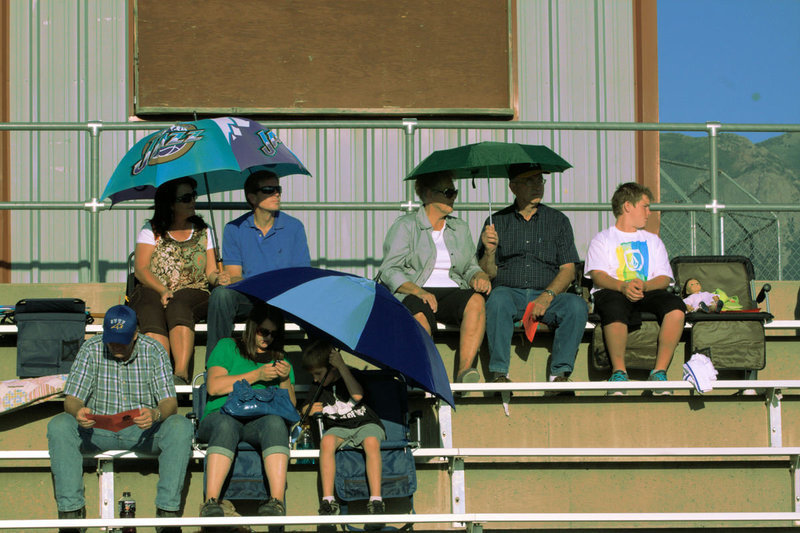 Image: Fans try to create a bit of shade while they watch the pre-game.