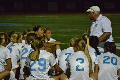 Image: Coach Geddes gives halftime speech to team.