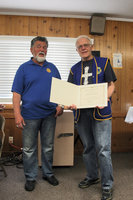 Image: Tom Karren, zone chairman of the Lions, presenting recognition award to Richard Criddle.